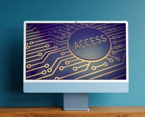 computer monitor on table top showing an image of a circuit board with the word "access" on the screen