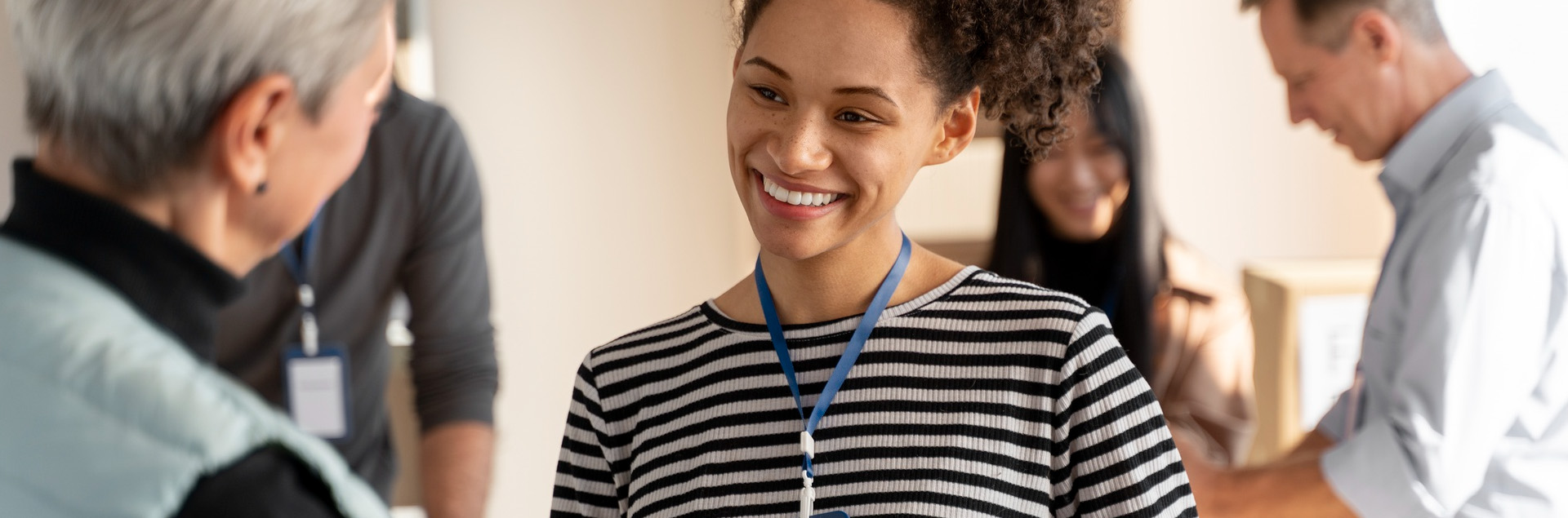 young woman talking with an older woman at a college event