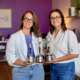 Dunn Marketing leadership including CEO & Brand Strategist Laura Dunn (left) and VP Client Services Marci Seney (right) holding the agency's 3 Communicator Award statues for 2026 at their Danielson office