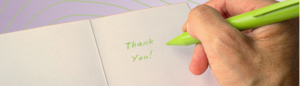 Person writing thank you note