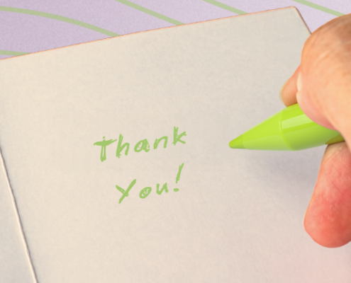 Person writing thank you note