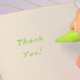 Person writing thank you note