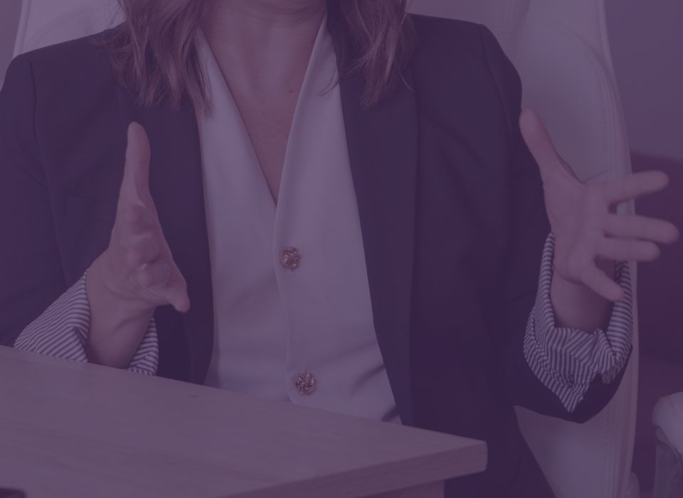 a closeup of a business woman's hands held out with fingers splayed as she shares information